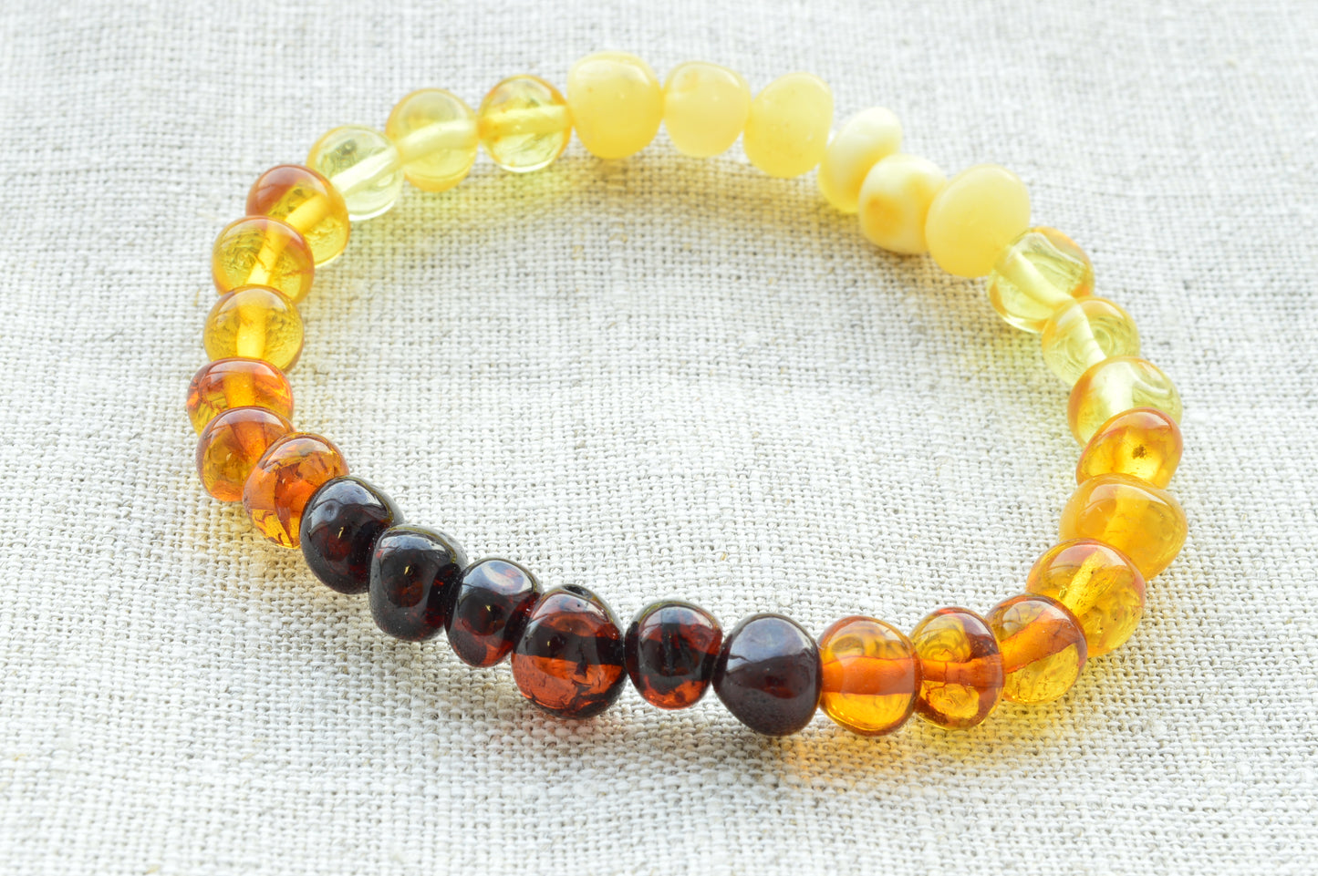 Multicolored beaded bracelet on a light fabric background