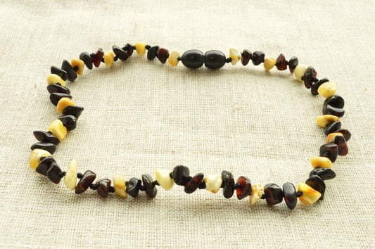 Necklace with multicolored beads on a textured beige background