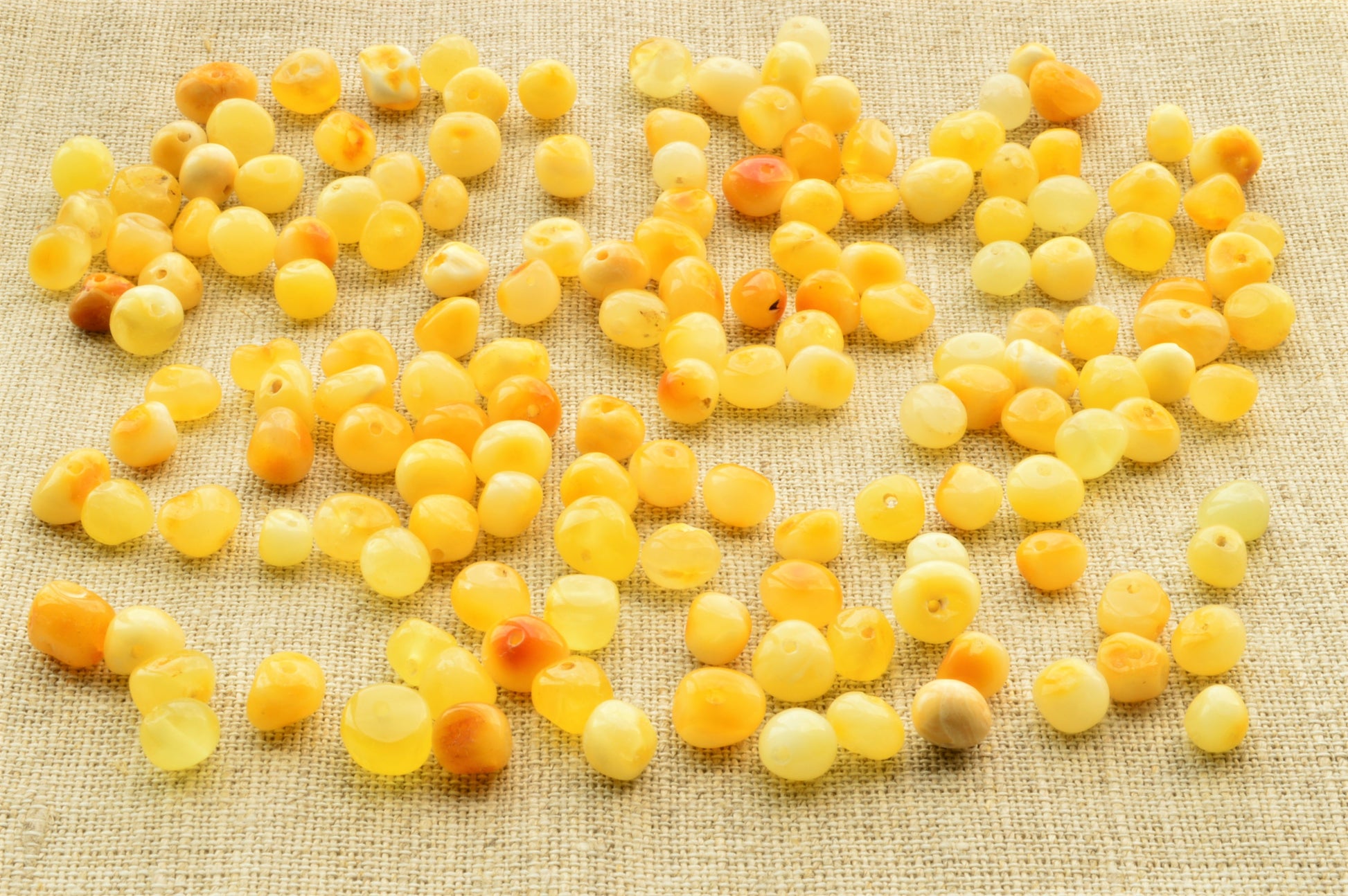 Yellow berries scattered on a textured fabric surface