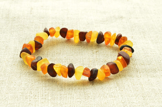 Multicolored beaded bracelet on a textured beige background