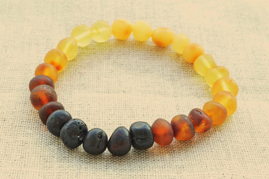 Multicolored beaded bracelet on a textured beige background