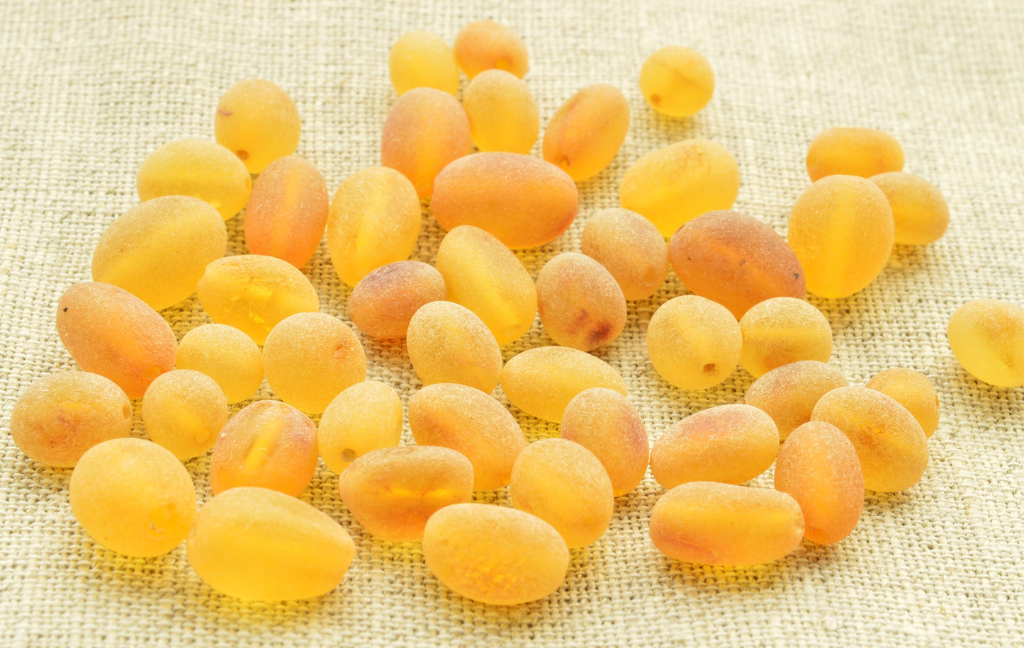 Yellow amber on a textured beige background