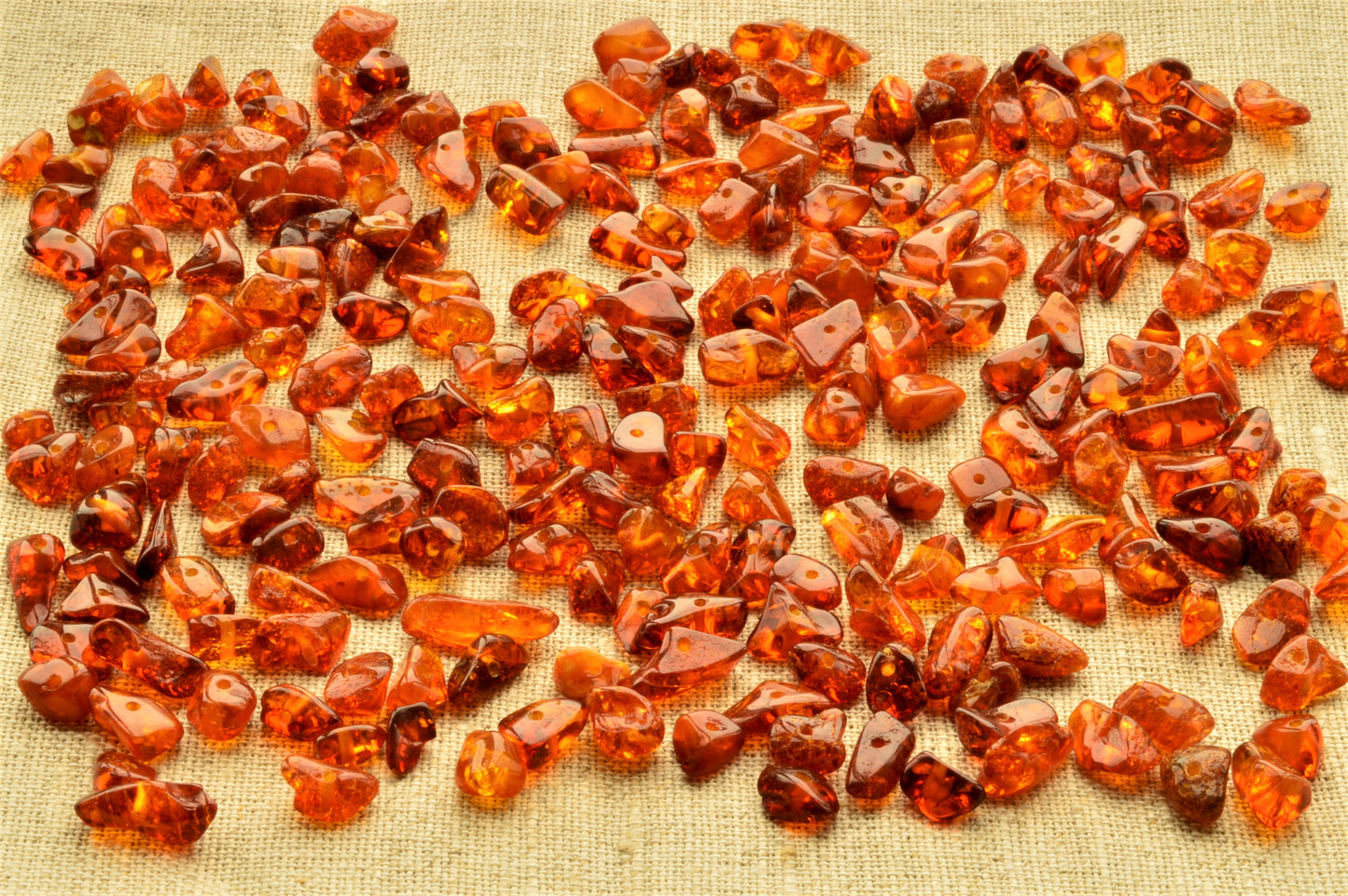 Collection of amber stones on a textured fabric background