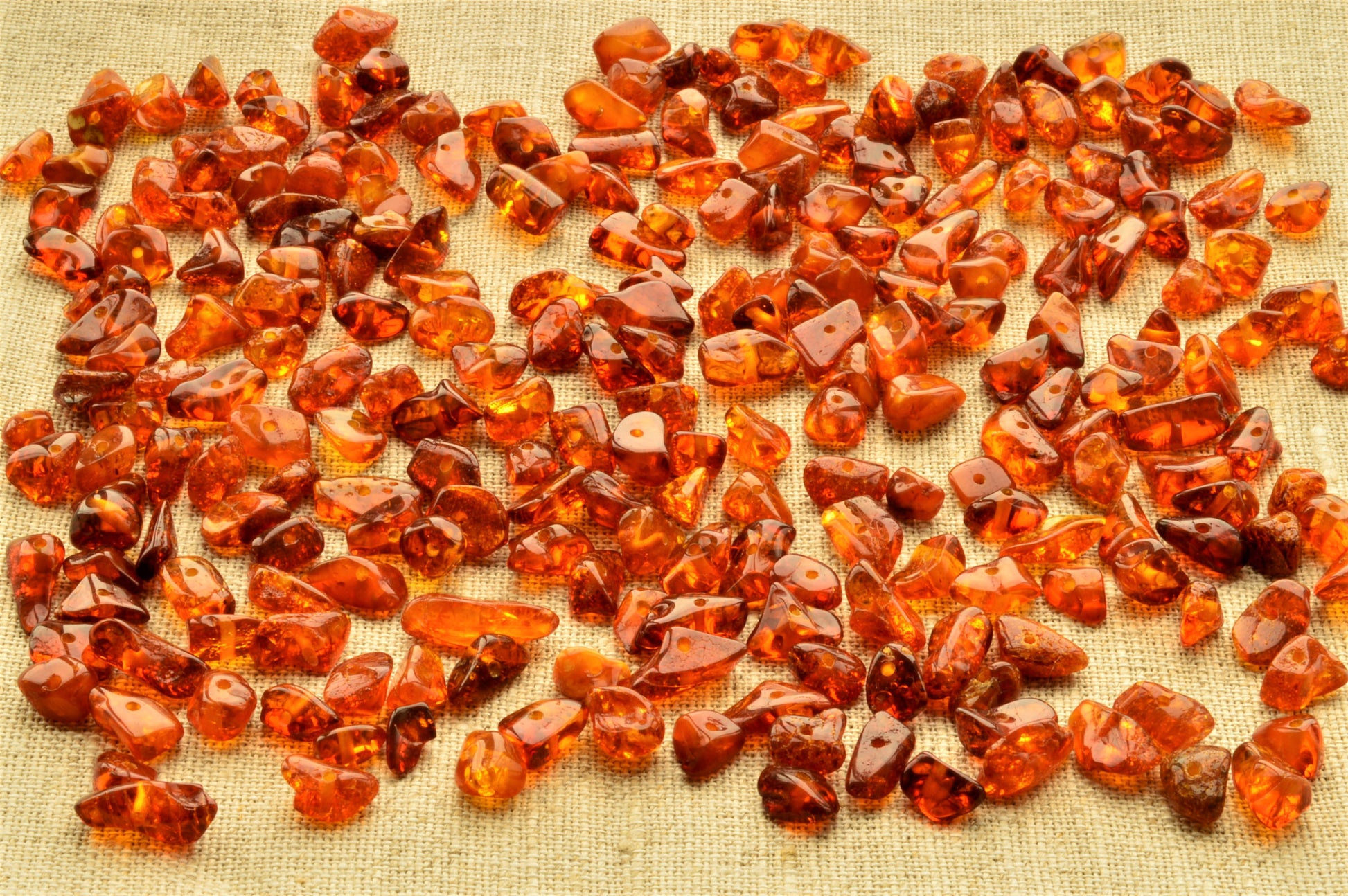 Collection of amber stones on a textured fabric background